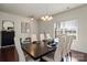 Bright dining room with hardwood floors, a large dining table set for a formal dinner at 5703 Eleanor Rigby Rd, Charlotte, NC 28278