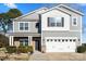Two-story home featuring gray siding, white trim, and a two-car garage at 5703 Eleanor Rigby Rd, Charlotte, NC 28278