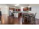 Open kitchen with stainless appliances, granite counters, island, and dining table at 5703 Eleanor Rigby Rd, Charlotte, NC 28278