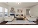 Bright living room featuring neutral furniture, decorative fireplace, and hardwood floors at 5703 Eleanor Rigby Rd, Charlotte, NC 28278