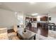 Open-concept living room featuring hardwood floors with easy access to the kitchen and dining area at 5703 Eleanor Rigby Rd, Charlotte, NC 28278