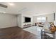 Sunlit living room featuring a cozy sectional, playful teepee, and mounted TV, creating a perfect gathering space at 5703 Eleanor Rigby Rd, Charlotte, NC 28278