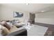 Comfortable living space with a sectional sofa, stylish decor, and plenty of natural light throughout the room at 5703 Eleanor Rigby Rd, Charlotte, NC 28278