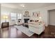 Bright living room featuring neutral furniture, a decorative fireplace, and hardwood floors at 5703 Eleanor Rigby Rd, Charlotte, NC 28278