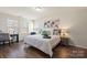 Well-lit main bedroom featuring hardwood floors, providing a comfortable and serene retreat at 5703 Eleanor Rigby Rd, Charlotte, NC 28278