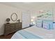 Serene main bedroom with soft blue accents, a dresser, and a plush bed with decorative pillows at 5703 Eleanor Rigby Rd, Charlotte, NC 28278