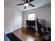 Bedroom featuring hardwood floors, a black ceiling fan and a TV on a black TV stand at 5743 Cherrycrest Ln, Charlotte, NC 28217