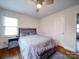 Comfortable bedroom featuring hardwood floors, a gray bedspread, and natural light at 5743 Cherrycrest Ln, Charlotte, NC 28217