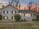 Charming white brick home with a well maintained yard, trimmed bushes and a quaint covered porch at 5743 Cherrycrest Ln, Charlotte, NC 28217