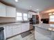 Modern kitchen with white cabinets, granite countertops, stainless steel appliances, and a stylish backsplash at 5743 Cherrycrest Ln, Charlotte, NC 28217