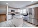 Well-lit kitchen with white cabinetry, stainless steel appliances, center island, and granite countertops at 5743 Cherrycrest Ln, Charlotte, NC 28217
