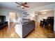 Spacious living room featuring hardwood floors, a ceiling fan, and an open layout to the dining area at 5743 Cherrycrest Ln, Charlotte, NC 28217