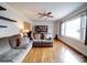 Inviting living room with hardwood floors, large window, and a comfortable gray sofa at 5743 Cherrycrest Ln, Charlotte, NC 28217