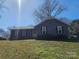 Charming single-story home with gray siding, black shutters, and a red front door at 5815 Katrine Ct, Charlotte, NC 28208