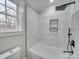 Updated bathroom with sleek tile, modern fixtures, and a separate shower and tub at 588 Washington Ln, Albemarle, NC 28001