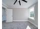 Bright bedroom features neutral walls, white trim, a large window, and modern ceiling fan at 588 Washington Ln, Albemarle, NC 28001