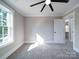 Bright, carpeted bedroom with a large window and a view into the house at 588 Washington Ln, Albemarle, NC 28001