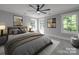 Comfortable bedroom with large windows, warm lighting, cozy decor, and neutral color scheme at 588 Washington Ln, Albemarle, NC 28001