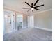 Bedroom with en suite bathroom, walk-in closet, neutral walls, carpet, and modern ceiling fan at 588 Washington Ln, Albemarle, NC 28001