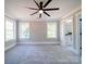 Spacious bedroom with plush carpet, neutral walls, and two large windows with natural light at 588 Washington Ln, Albemarle, NC 28001