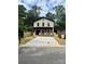 Charming brick two-story home with a long concrete driveway and fenced yard at 588 Washington Ln, Albemarle, NC 28001
