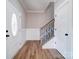Elegant foyer with hardwood floors, a staircase with decorative iron railings, and a well-lit, welcoming space at 588 Washington Ln, Albemarle, NC 28001