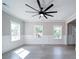 Airy living room featuring clean lines and natural light through two windows, complemented with an oversized ceiling fan at 588 Washington Ln, Albemarle, NC 28001