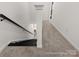 Interior shot of a carpeted hallway with a staircase and white walls leading to additional rooms at 602 Station St # 39, Clover, SC 29710
