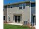 Backyard with lawn, a sliding door with windows above, gray siding, and utility meters at #603 Mt. Mitchell Ave # 603, Gastonia, NC 28052