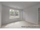 Bright, carpeted bedroom featuring large window and closet at #603 Mt. Mitchell Ave # 603, Gastonia, NC 28052