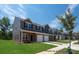 New townhome exterior with brick accents, attached garages, green lawn, and professional landscaping at #603 Mt. Mitchell Ave # 603, Gastonia, NC 28052