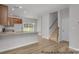 Open concept kitchen featuring stainless appliances, stone countertops, light wood floors, and access to stairs at #603 Mt. Mitchell Ave # 603, Gastonia, NC 28052