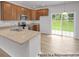 Modern kitchen featuring stainless appliances, stone countertops, light wood floors, and sliding glass doors to the yard at #603 Mt. Mitchell Ave # 603, Gastonia, NC 28052