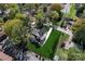 Aerial view of home with mature trees, large yard, and fenced-in backyard at 621 Poindexter Dr, Charlotte, NC 28209