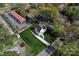 Aerial view of a beautiful home with a lush green lawn, a long driveway, and mature trees at 621 Poindexter Dr, Charlotte, NC 28209