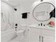 Modern bathroom with a tub-shower, a sleek vanity, and stylish black accents at 621 Poindexter Dr, Charlotte, NC 28209