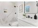 Bright bathroom features a marble walk-in shower and sleek vanity with modern fixtures at 621 Poindexter Dr, Charlotte, NC 28209