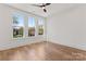 Sun-filled bedroom with hardwood floors and large windows offering scenic views at 621 Poindexter Dr, Charlotte, NC 28209