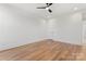 Minimalist bedroom with hardwood floors, a ceiling fan, and ample natural light at 621 Poindexter Dr, Charlotte, NC 28209