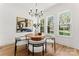 Bright dining room featuring a modern chandelier and a round table with seating for four at 621 Poindexter Dr, Charlotte, NC 28209