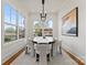 Bright dining room with a modern chandelier, large windows, and seating for eight at 621 Poindexter Dr, Charlotte, NC 28209