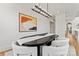 Elegant dining room with modern chandelier and oval table with seating for eight guests at 621 Poindexter Dr, Charlotte, NC 28209