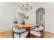 Cozy dining room with a round table, modern chandelier, and white walls with arched doorways at 621 Poindexter Dr, Charlotte, NC 28209