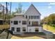Three-story home with modern black trim, light siding, and a balcony overlooking the backyard at 621 Poindexter Dr, Charlotte, NC 28209