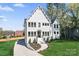 Stunning two-story white home with modern black-framed windows and a beautifully landscaped front yard at 621 Poindexter Dr, Charlotte, NC 28209
