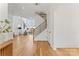 Bright foyer with hardwood floors, modern staircase, and open view to living area at 621 Poindexter Dr, Charlotte, NC 28209