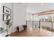 Upstairs hallway with hardwood floors, modern railing, and cozy bench seat at 621 Poindexter Dr, Charlotte, NC 28209