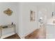 Bright hallway with hardwood floors, accent furniture, and arched doorway to another room at 621 Poindexter Dr, Charlotte, NC 28209
