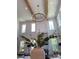 Dramatic living room boasting high ceilings, clerestory windows and statement lighting fixture above fireplace at 621 Poindexter Dr, Charlotte, NC 28209