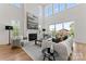 Spacious living room featuring high ceilings, large windows, and fireplace at 621 Poindexter Dr, Charlotte, NC 28209